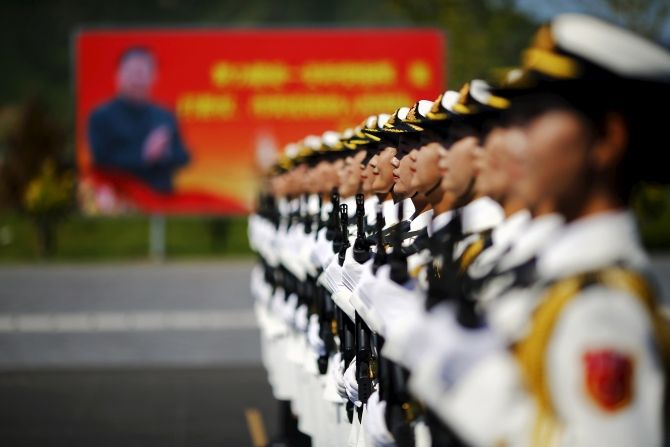 A billboard with Chinese President Xi Jinping behind People's Liberation Army soldiers in Beijing. Photograph: Damir Sagolj/Reuters