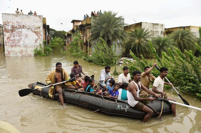 People being rescued from inundated Kotturpuram locality after heavy rains in Chennai. 
