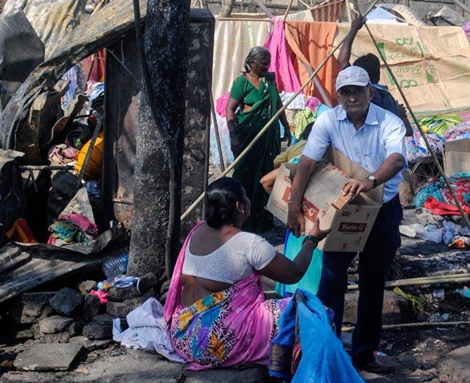 An NGO worker distributing relief material to the victims