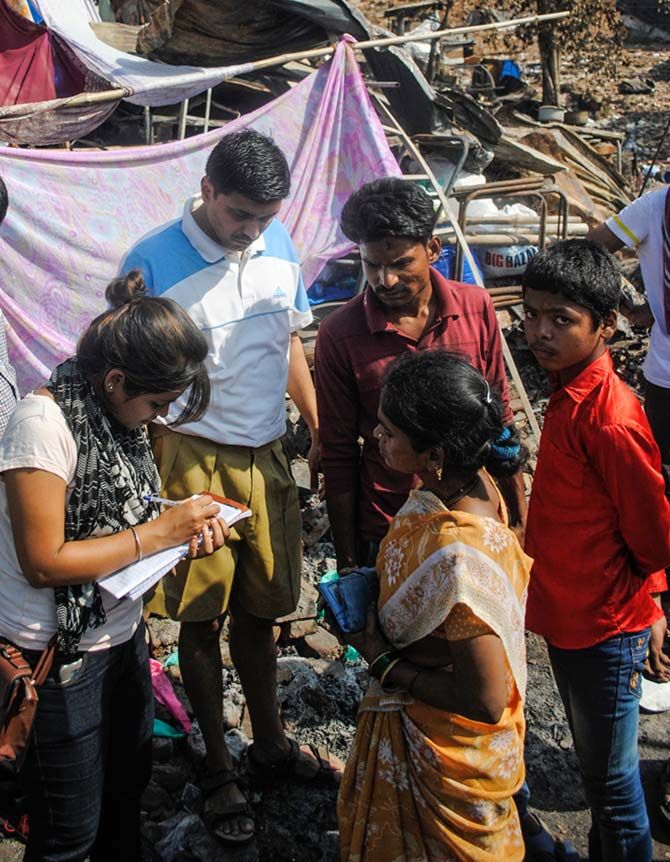The RSS worker, Rajesh Kulkarni assisting two college students help streamline the flow of relief material to the victims
