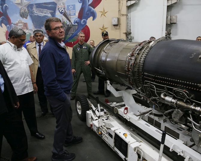 US Defence Secretary Dr Ashton Carter and Defence Minister Manohar Parrikar inspect a jet engine in the hanger deck aboard the USS Dwight D Eisenhower. Photograph: Mark Wilson/Getty Images