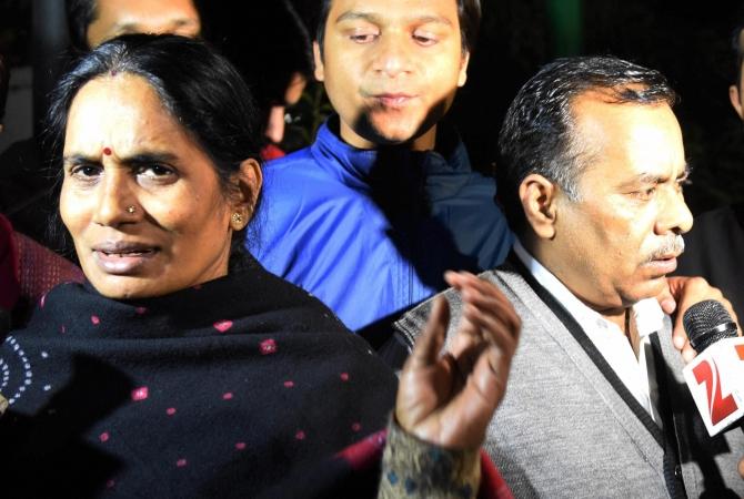 Badrinath Singh and Asha Devi, the December 16, 2012 victim's parents, emerge from Parliament after the Rajya Sabha passed the new law for juvenile crime. Photograph: Subhav Shukla/PTI