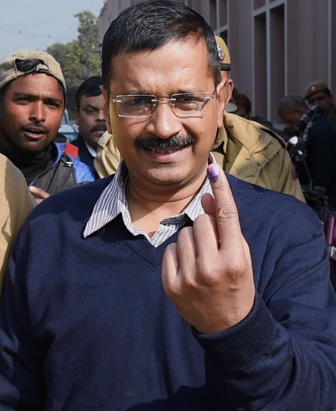 Aam Aadmi Party chief Arvind Kejriwal flashes his finger after casting his vote.