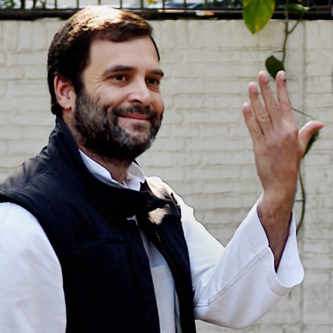 Congress Vice-President Rahul Gandhi flashes a smile and his finger after voting.