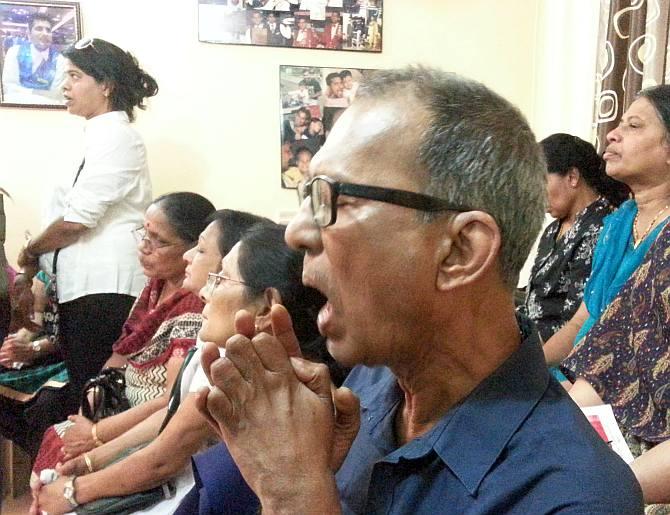 From right: Russel's father Frank and mother Gladys praying for Russel