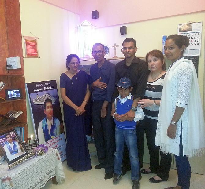 From right: Gladys, Frank, Kevin, his Italian wife Roxanne, Rhys and Wilma next to Russel's poster and memorabilia