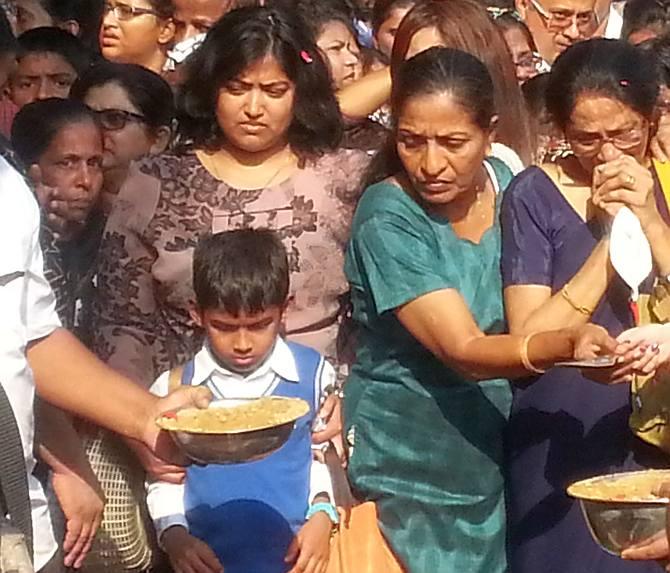 Gladys and Rhys paying their final tributes in Russel's memory after his coffin was lowered in the burial ground