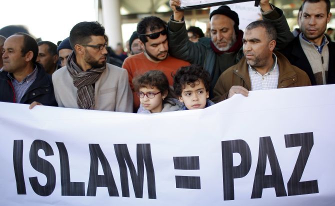 Muslims with a banner that reads 'Islam = Peace' at a rally outside Madrid's Atocha train station. Photograph: Juan Medina/Reuters