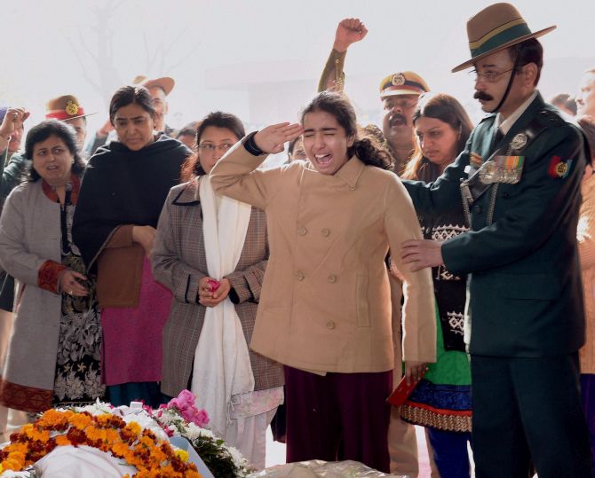 Colonel M N Rai's daughter gives the Gorkha regiment's war cry as she salutes her father who made the ultimate sacrifice for the motherland fighting terrorists in  south Kashmir's Pulwama district in January 2015. Photograph: Manvender Vashist/PTI Photo