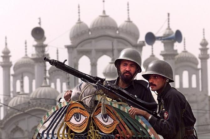 Image: Policemen stand guard at Quetta's central mosque. Photograph: Jerry Lampen/Reuters