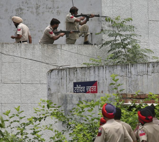 Policemen take positions next to a police station during a gunfight with terrorists at Dinanagar town in Gurdaspur district. Photograph: Munish Sharma/Reuters