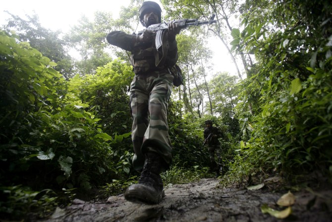 An Indian soldier patrols along the Indo-Mayanmar border