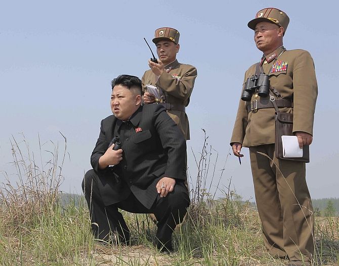 Kim Jong-un guides a multiple-rocket launch drill. Photograph: Reuters