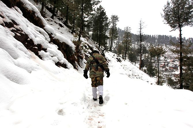 A soldier patrols the LOC