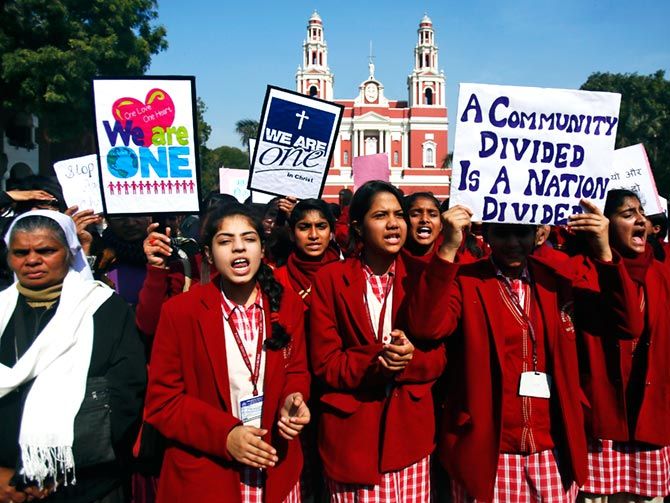 Demonstrators protest outside a church in New Delhi. 