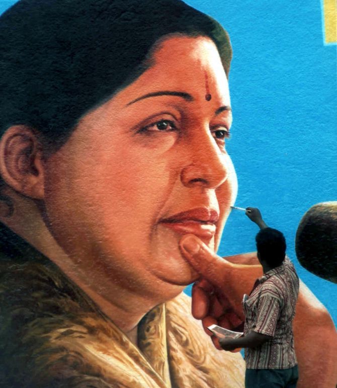 A man paints a portrait of Tamil Nadu Chief Minister J Jayalaithaa