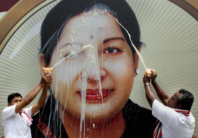 All India Anna Dravida Munnetra Kazhagam supporters perform milk abhishekam on a poster of AIADMK General Secretary and Chief Minister J Jayalalithaa, in Madurai. Photograph: PTI