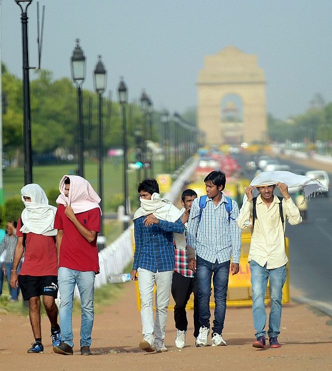 : Boys covering their faces on a hot day near India Gate in New Delhi. Photograph: Manvender Vashist/PTI Photo