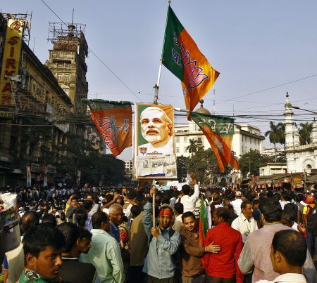 A supporter of Bharatiya Janata Party holds a placard with a picture of Prime Minister Narendra Modi.
