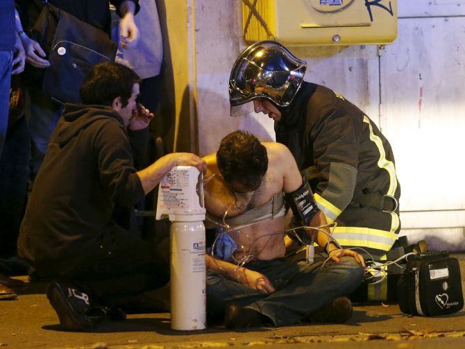 French security help an injured Frenchman near the Bataclan concert hall, the scene of the worst terror attack in Paris that horrific Friday night. Photograph: Christian Hartmann/Reuters