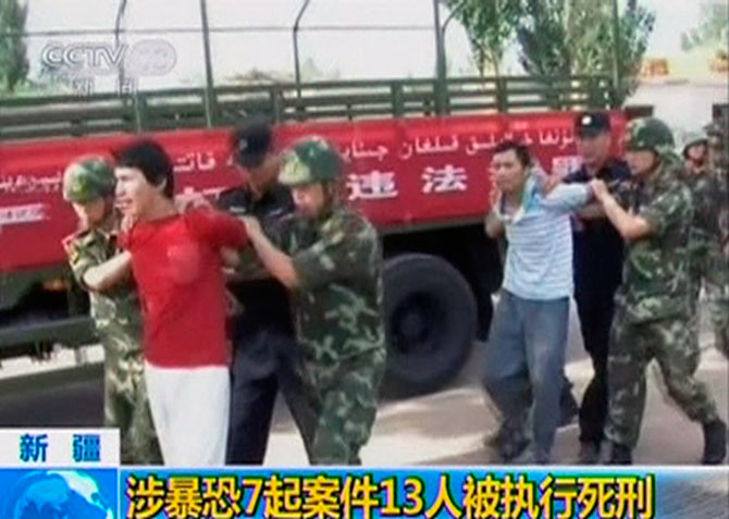 The men -- China claims were 'terrorists' -- about to be executed, escorted by riot policemen, in the Xinjiang Uighur Autonomous Region, June 16, 2014. Photograph: Reuters