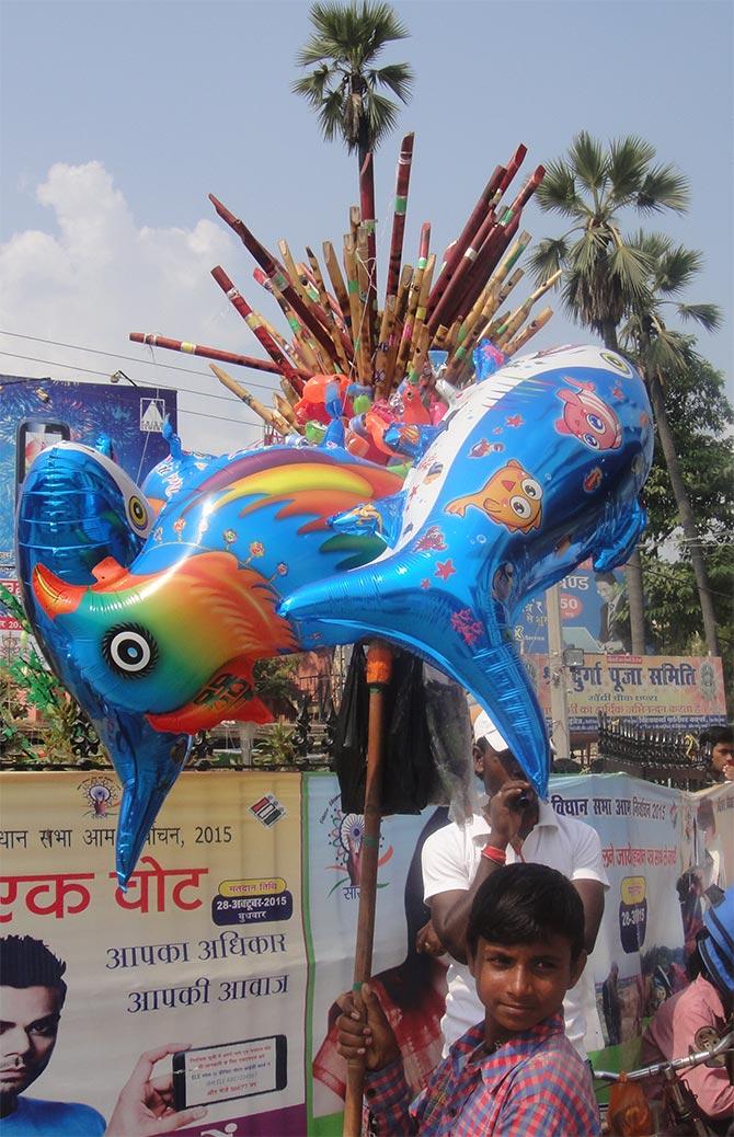 A boy selling plastic dolphins