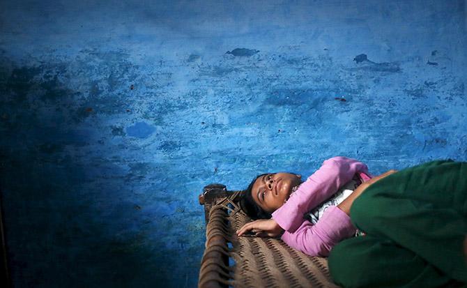 Sajida Saifi, daughter of Akhalaq Saifi, who was lynched by a mob, mourns his death inside her house at Bisara village in Uttar Pradesh, October 2.