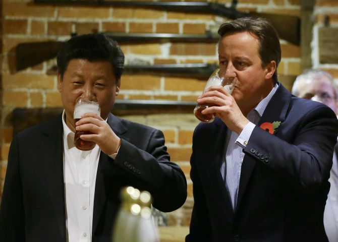 Xi Jinping and David Cameron enjoy a pint of lager at the The Plough at Cadsden pub. Photograph: Kirsty Wigglesworth-WPA Pool/Getty Images