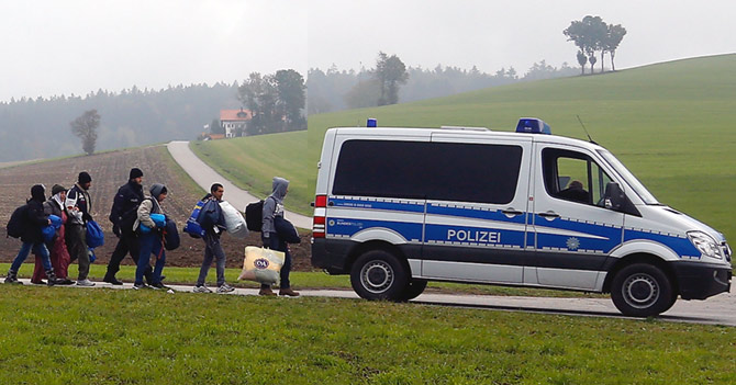 Migrants are escorted by German police to a registration centre, after crossing the Austrian-German border in Wegscheid near Passau, Germany, October 20.