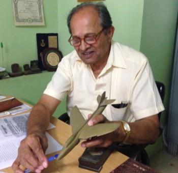 Group Captain D K Parulkar with a model of the aircraft he flew