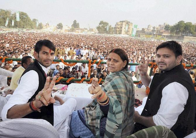 Tej Pratap, left, and Tejaswi Yadav flank their mother Rabri Devi.