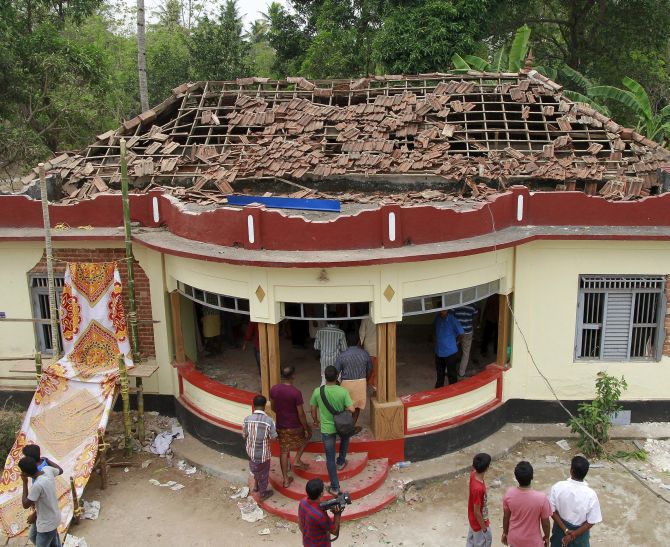 People at the damaged section of the Puttingal temple in  Kollam, Kerala after the fire, April 10, 2016, was extinguished. A huge fire swept through the temple, killing over 100 people. Photograph: Sivaram V/Reuters