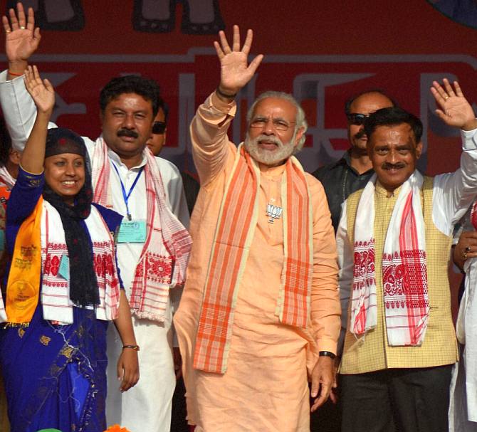 Prime Minister Narendra Modi with BJP candidates at an election rally at Barpeta Road, Assam