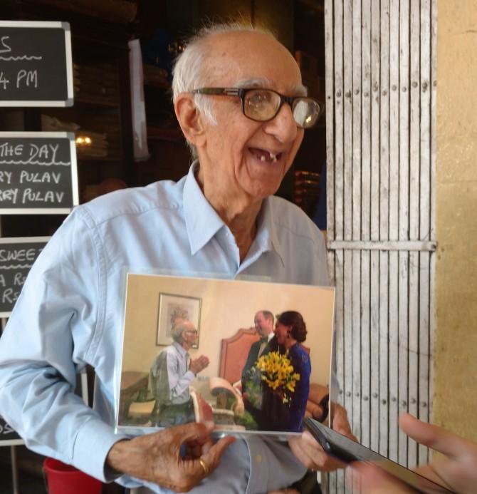 Boman Kohinoor holds up a photograph of his meeting with the royals