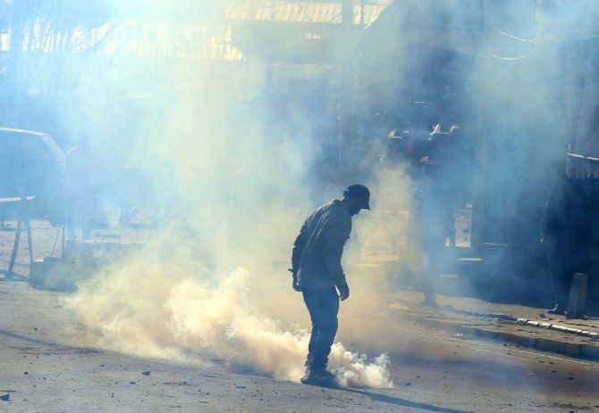 Police fire tear gas at protestors after the Hanwara incident, April 12. Photograph: Umar Ganie