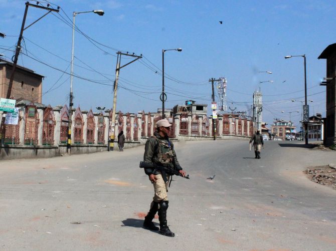 Security personnel patrol the barren streets after the Handwara incident