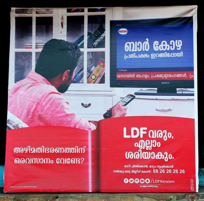 In this LDF election poster, a man with a remote in his hand watches a TV channel that talks about corruption on the shutting down bars in Kerala. Photograph: Sreeram Selvaraj