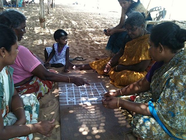 The protesters, who take turns at the venue, mark time with a game of Thaiyyam, a local version of checkers.