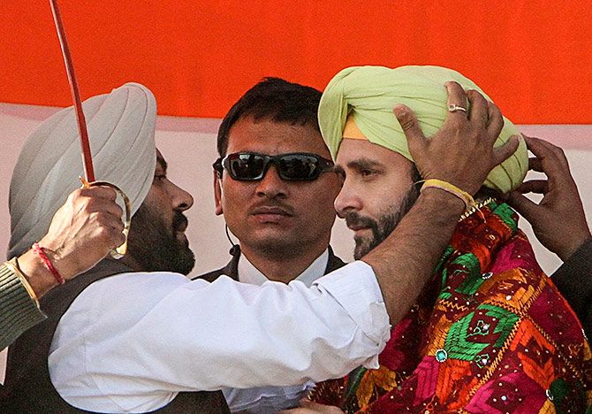 Rahul Gandhi is presented with a turban by his party supporters during a campaign rally ahead of state assembly elections at Sirhind in 2012.