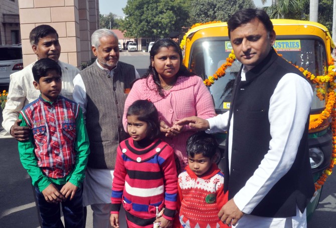 Uttar Pradesh Chief Minister Akhilesh Yadav presents an autorickshaw to Ruby Singhal. Photograph: Sandeep Pal