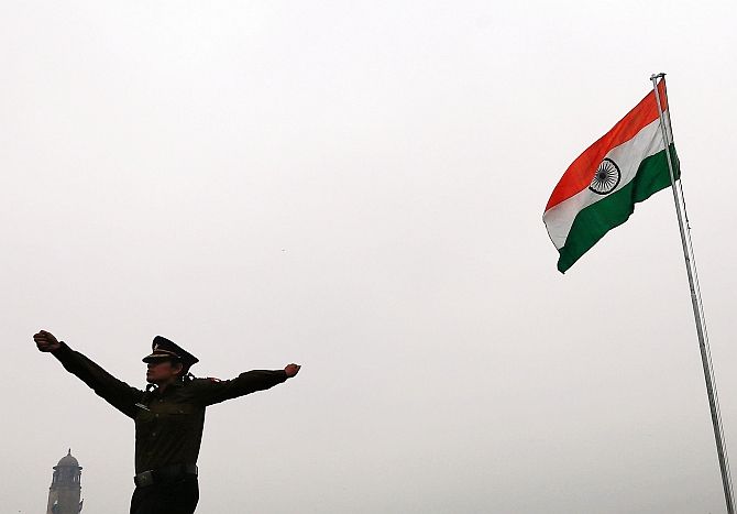 A soldier marches past the national flag in New Delhi. Photograph: Adnan Abidi/Reuters