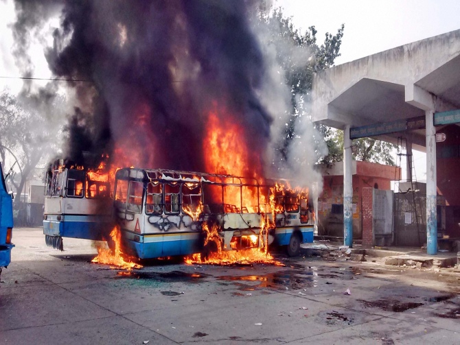 Buses set on fire in Sonepat. Photograph: Rajesh Sood/PTI