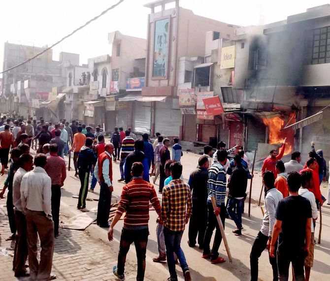 IMAGE: Protesters set shops on fire as the Jat agitation demanding reservation intensified in Sonepat, February 20, 2016. Photograph: PTI
