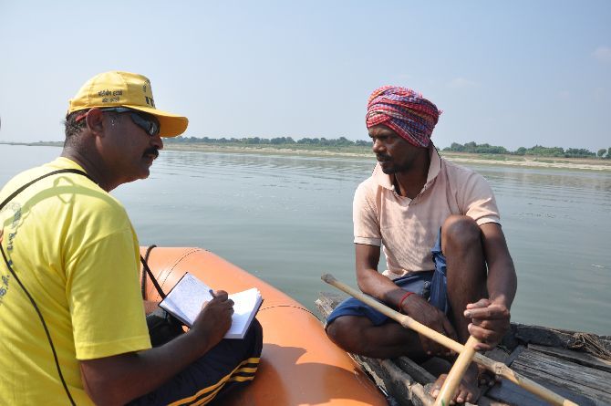 Surinder Khatri speaks  to a fisherman