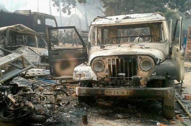 Vehicles set on fire after clashes between two groups at Kaliachak police station in Malda. Photograph: PTI
