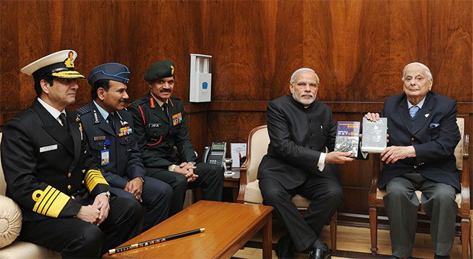 General J F R Jacob presents his books to Prime Minister Narendra Modi with the three service chiefs, Admiral Robin Dhawan, Air Chief Marshal Arup Raha and General Dalbir Singh, December 16, 2014. Photograph: Press Information Bureau