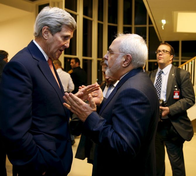 US Secretary of State John Kerry with Iranian Foreign Minister Mohammad Javad Zarif after the International Atomic Energy Agency verified that Iran has met all conditions under the nuclear deal, in Vienna. Photograph: Kevin Lamarque/Reuters