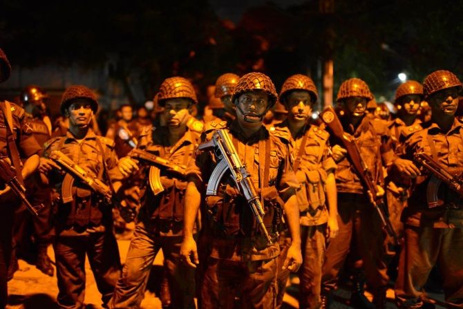 Bangladesh security personnel outside the restaurant. Photograph: Mahmud Hossain Opu/Getty Images