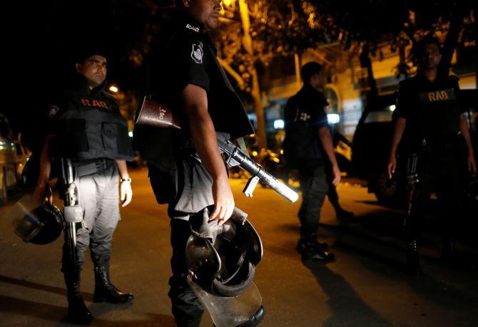 Bangladesh police personnel outside the scene of the attack in Dhaka
