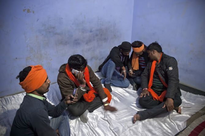 Gau rakshaks get tip-offs about possible cow smugglers in the area on their mobile phones. Photograph: Allison Joyce/Getty Images